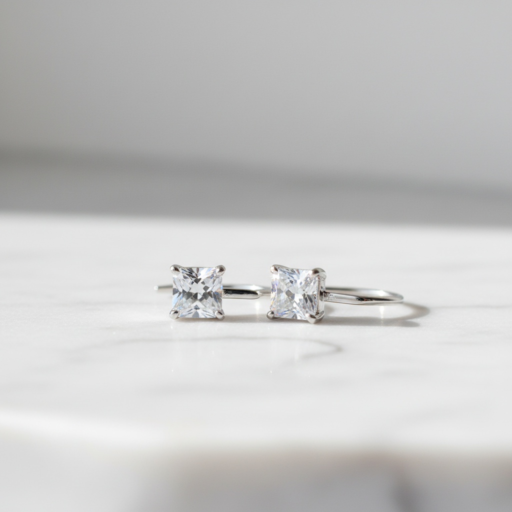 925 silver four-claw moissanite ear hook earrings on white marble