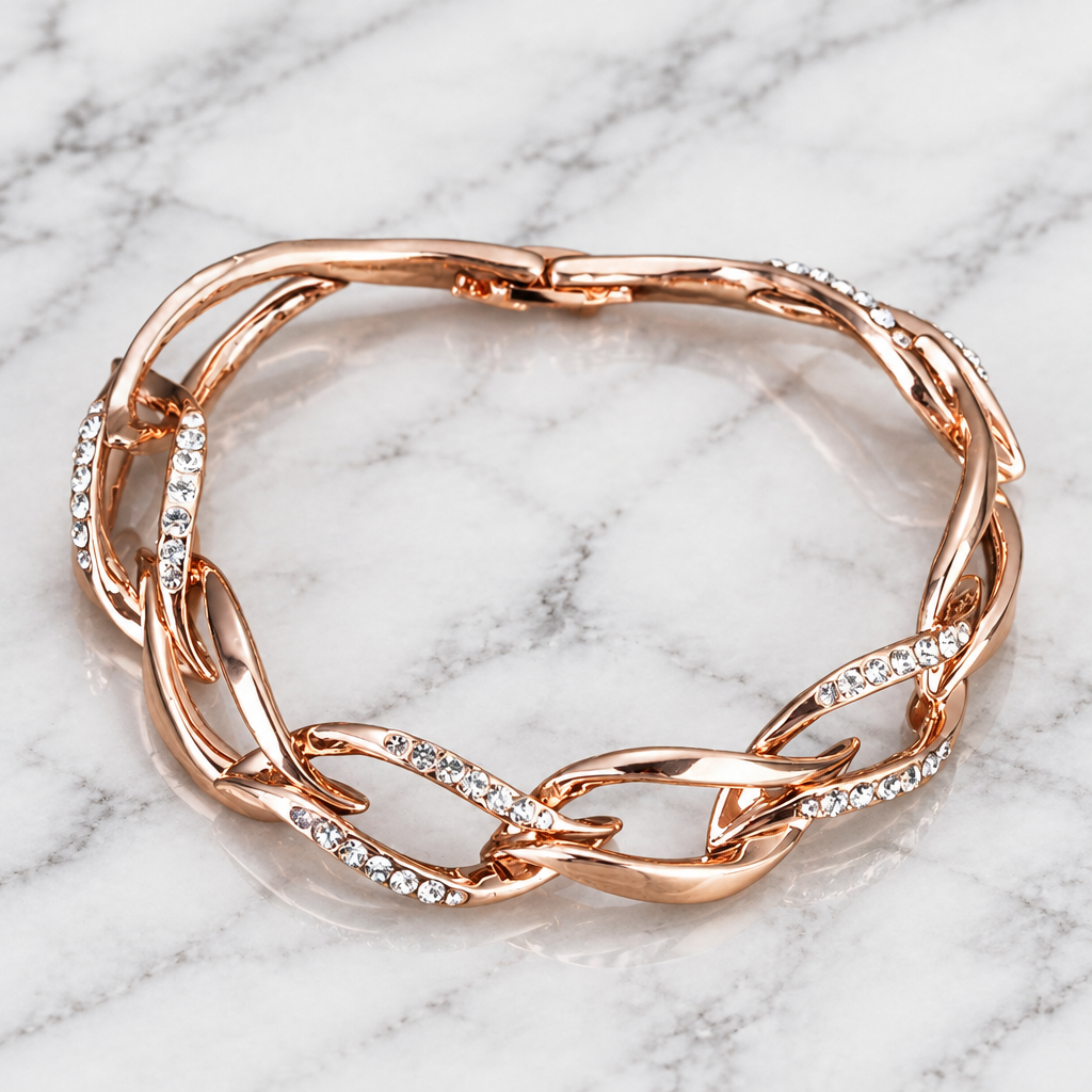 Rose gold-tone intertwined link bracelet with clear stone accents on white marble