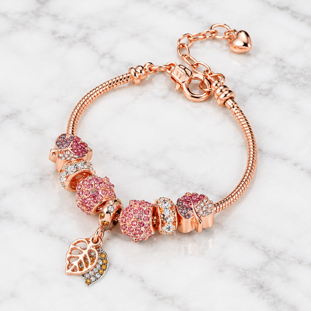 Fallen Leaf rose gold-tone charm bracelet with pink beads on white marble