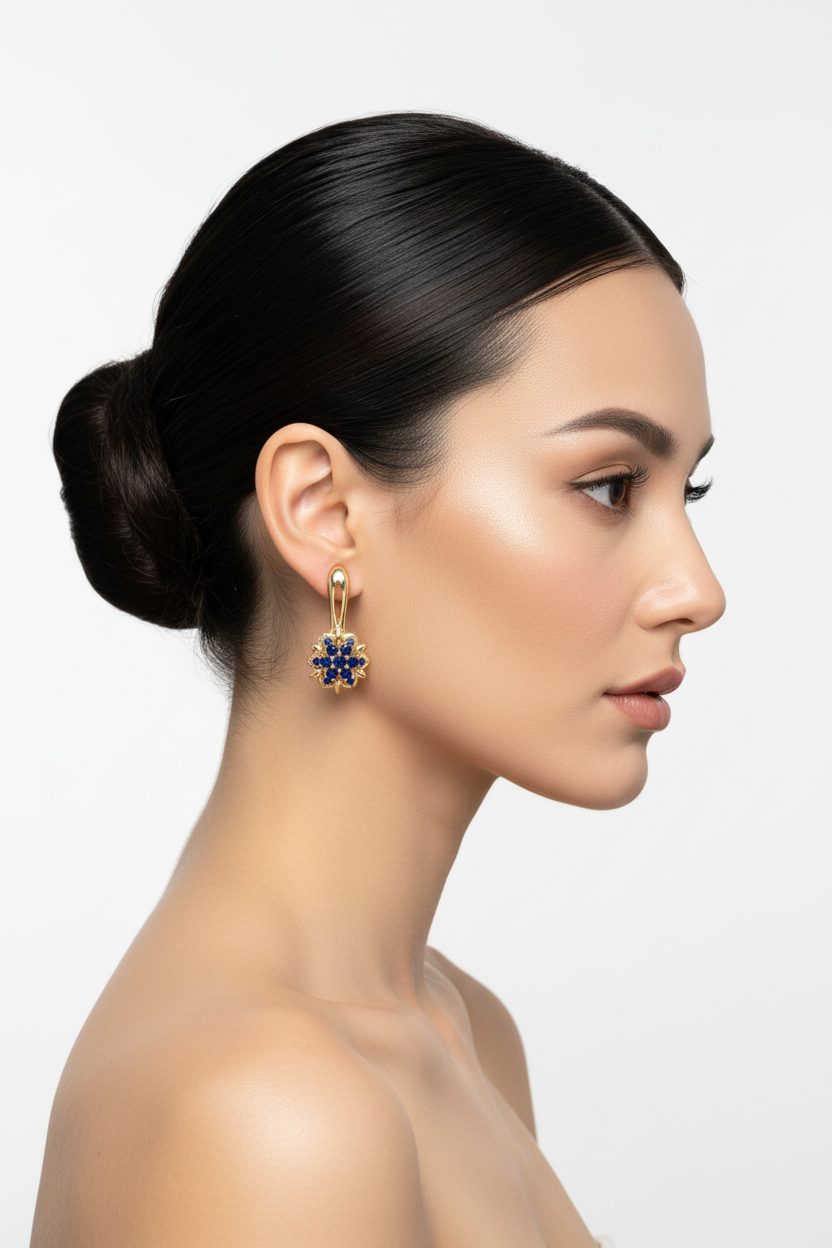 Woman right profile, ballerina bun, gold sapphire sunflower drop earrings