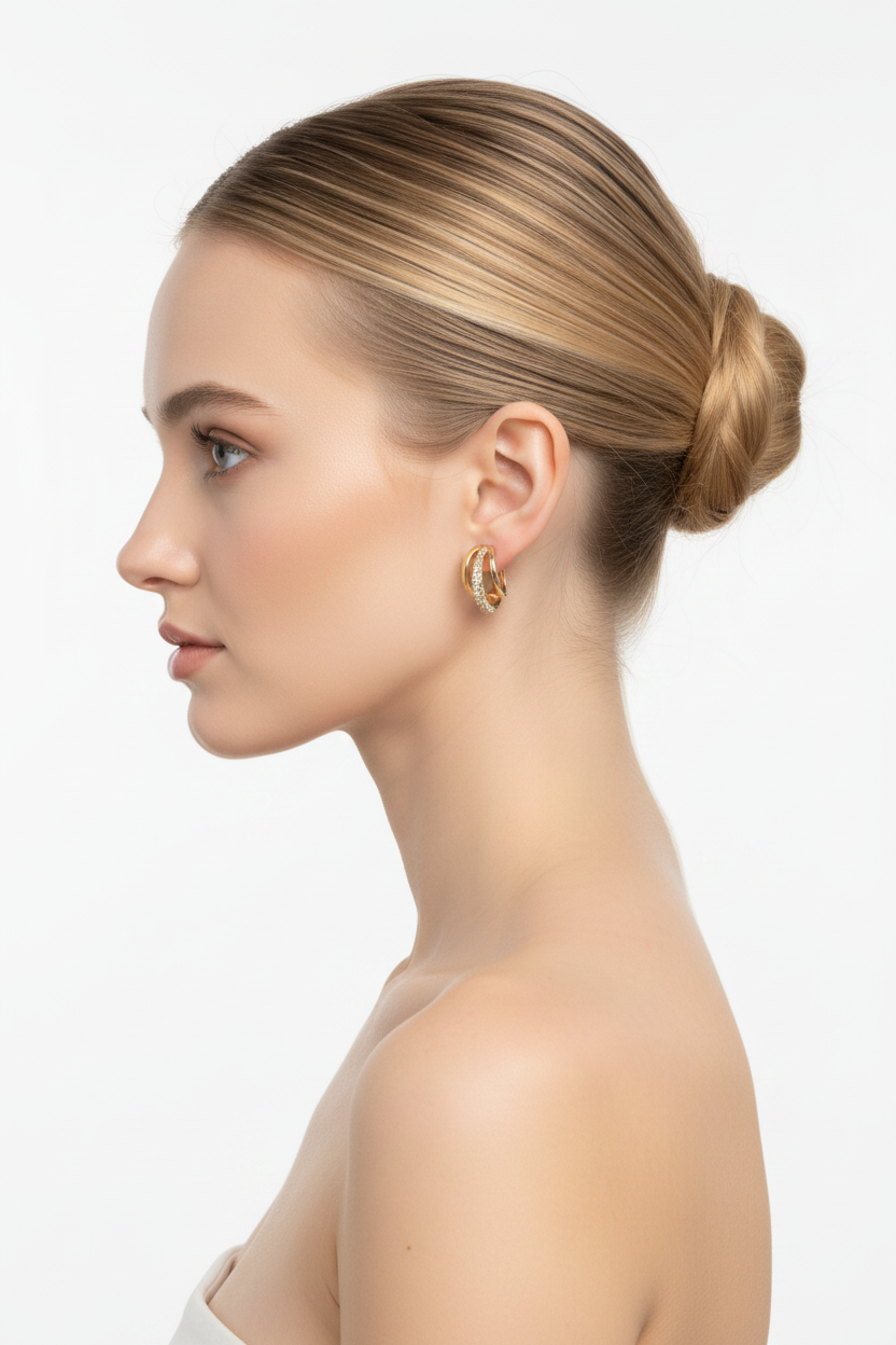 Woman left profile, ballerina bun, chunky gold huggie hoop earring