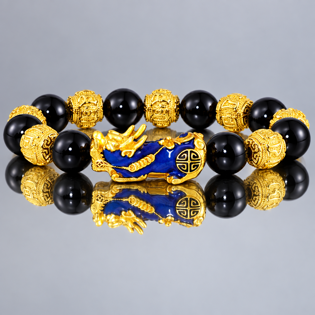 Black bead bracelet with blue and gold-tone Pixiu centerpiece reflected in a mirror