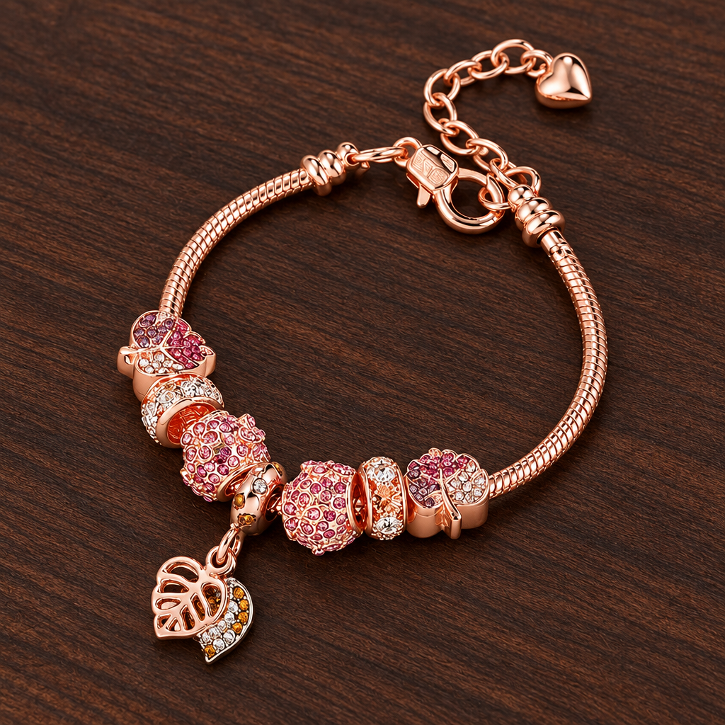 Fallen Leaf rose gold-tone charm bracelet with pink beads on dark wood