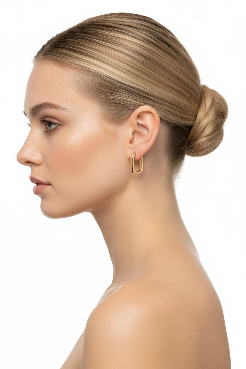 Blonde model in profile with ballerina bun wearing gold geometric rectangular hoop earrings