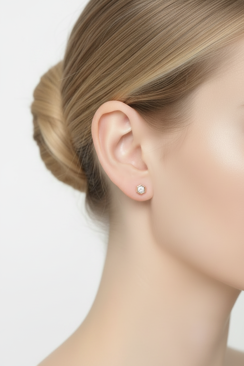 Blonde ballerina with hair bun wearing rose gold hexagonal zircon stud earring, right side profile