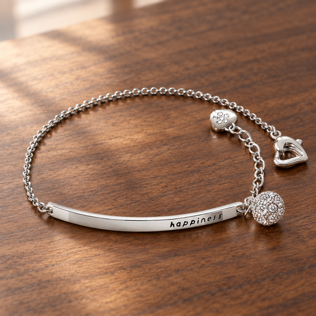 Silver-tone charm bracelet with cubic zirconia detail on a wooden table