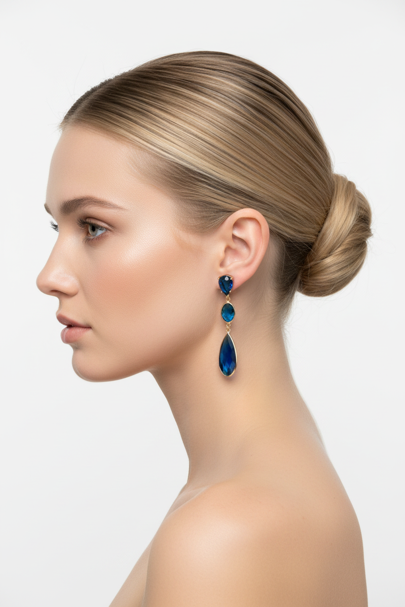 Blonde model with bun wearing blue crystal drop earrings - side profile