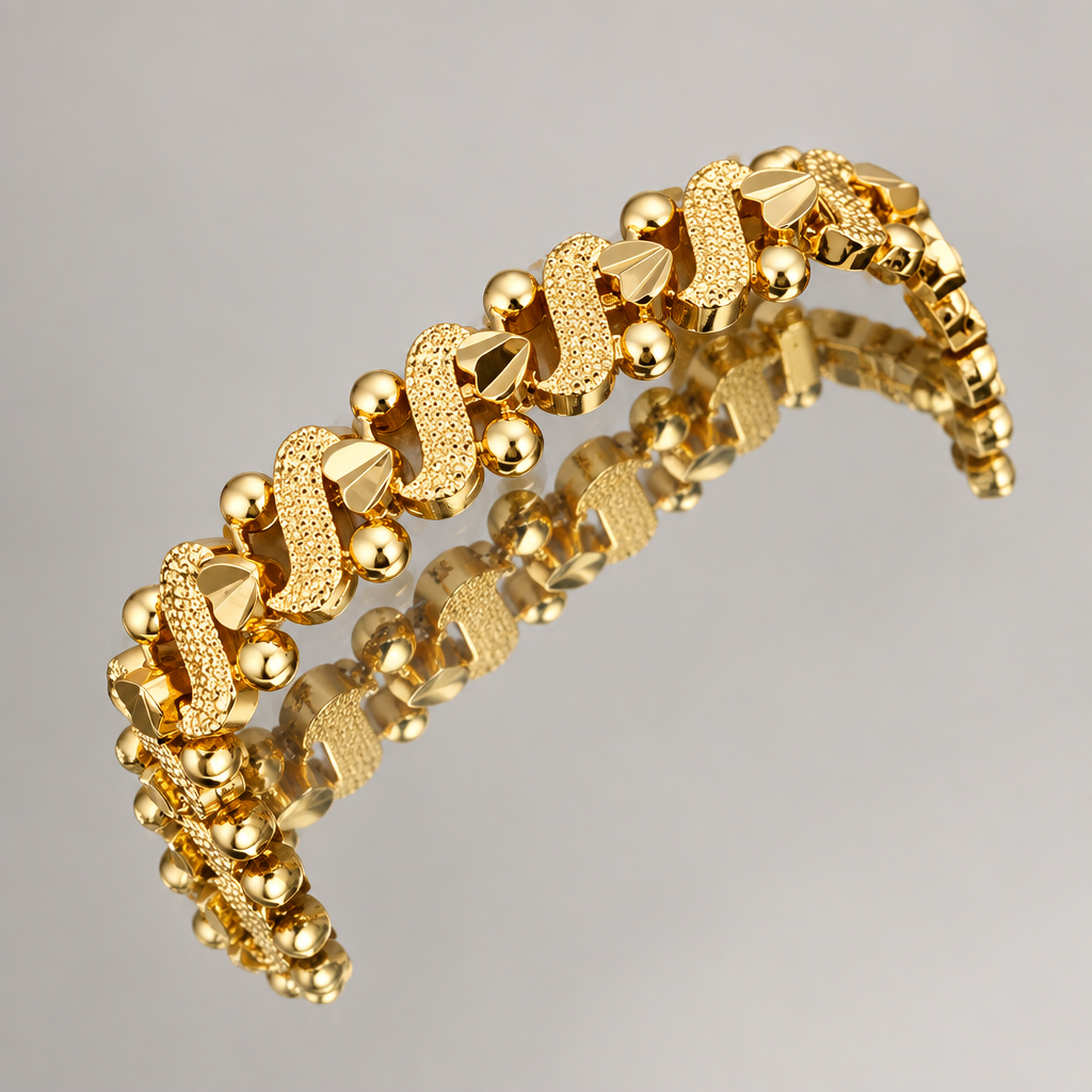 Gold-tone decorative bracelet with textured links reflected in a mirror