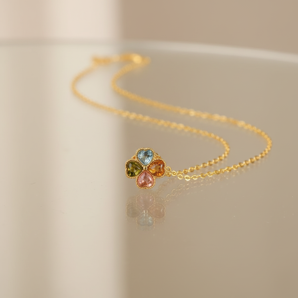 Tourmaline Four-Leaf Clover Necklace displayed on glass table
