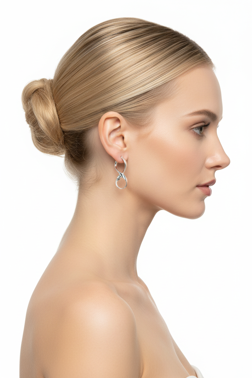 Blonde model with bun wearing silver infinity hoop earrings - side profile