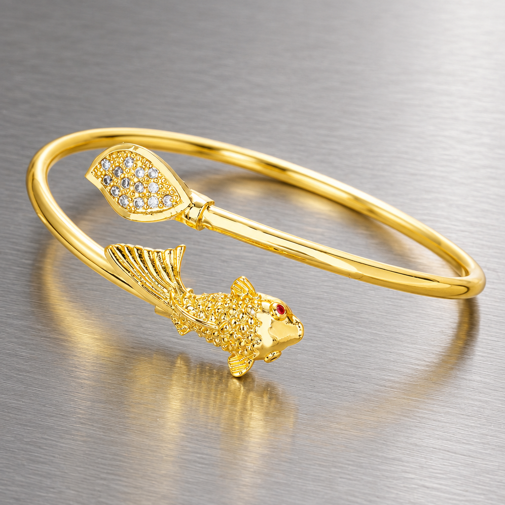 Gold-tone open fish and leaf cuff bracelet on brushed steel