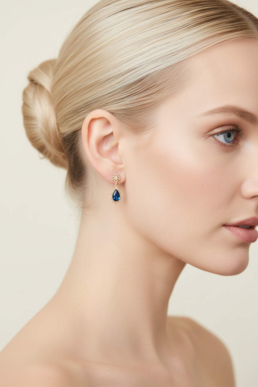 Nordic blonde model wearing delicate sapphire drop earrings - side profile