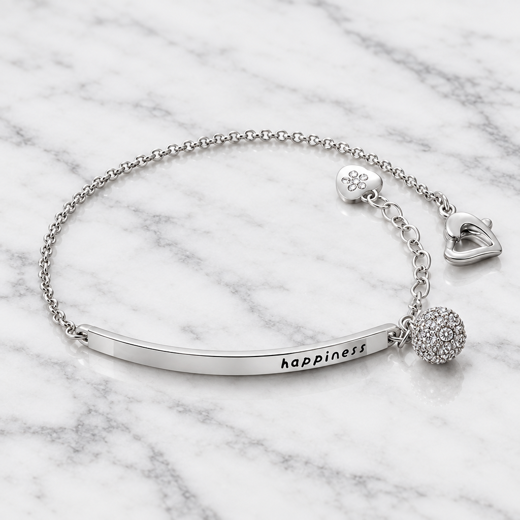 Silver-tone charm bracelet with cubic zirconia detail on white marble