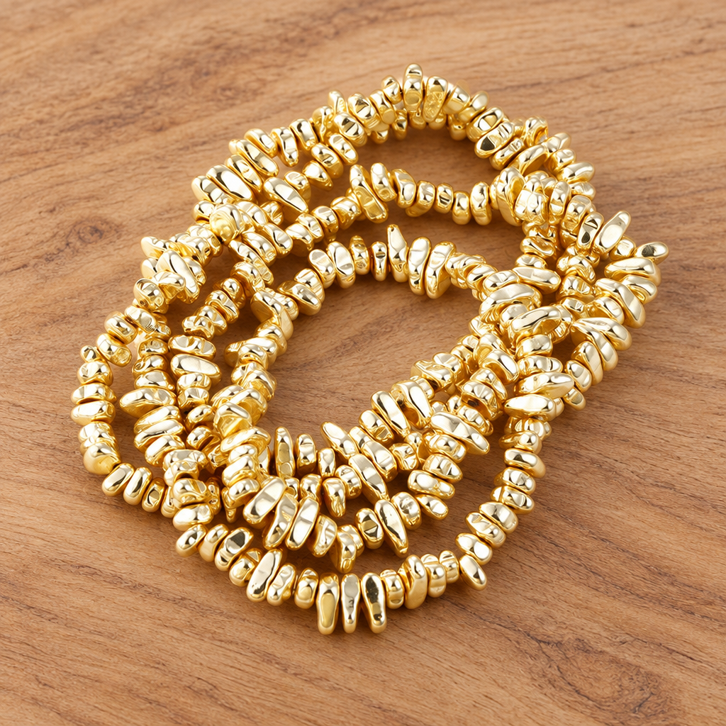 Gold-tone irregular bead bracelet on natural wood