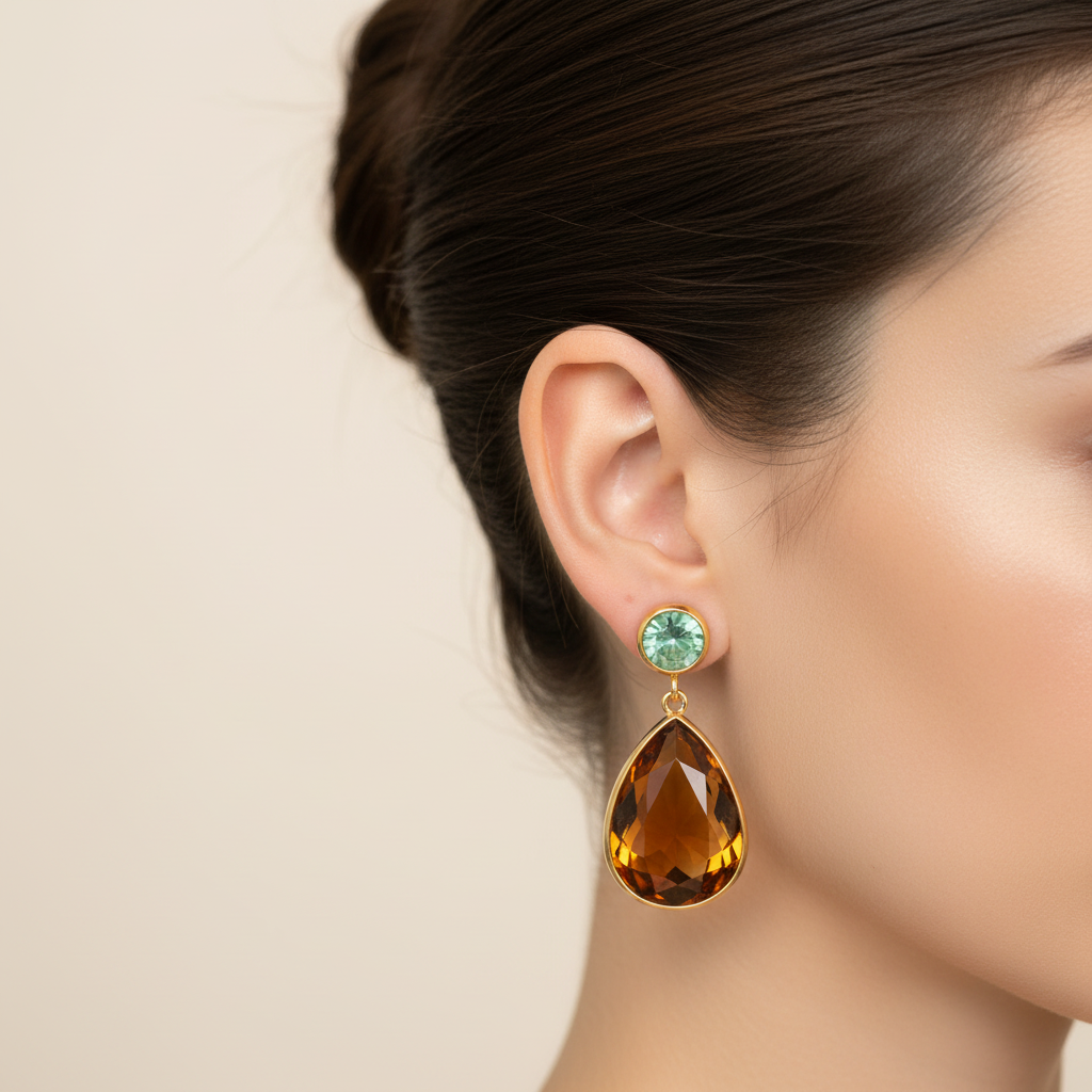 Close-up detail of gold waterdrop amber teardrop gemstone ear clips on model with ballerina bun