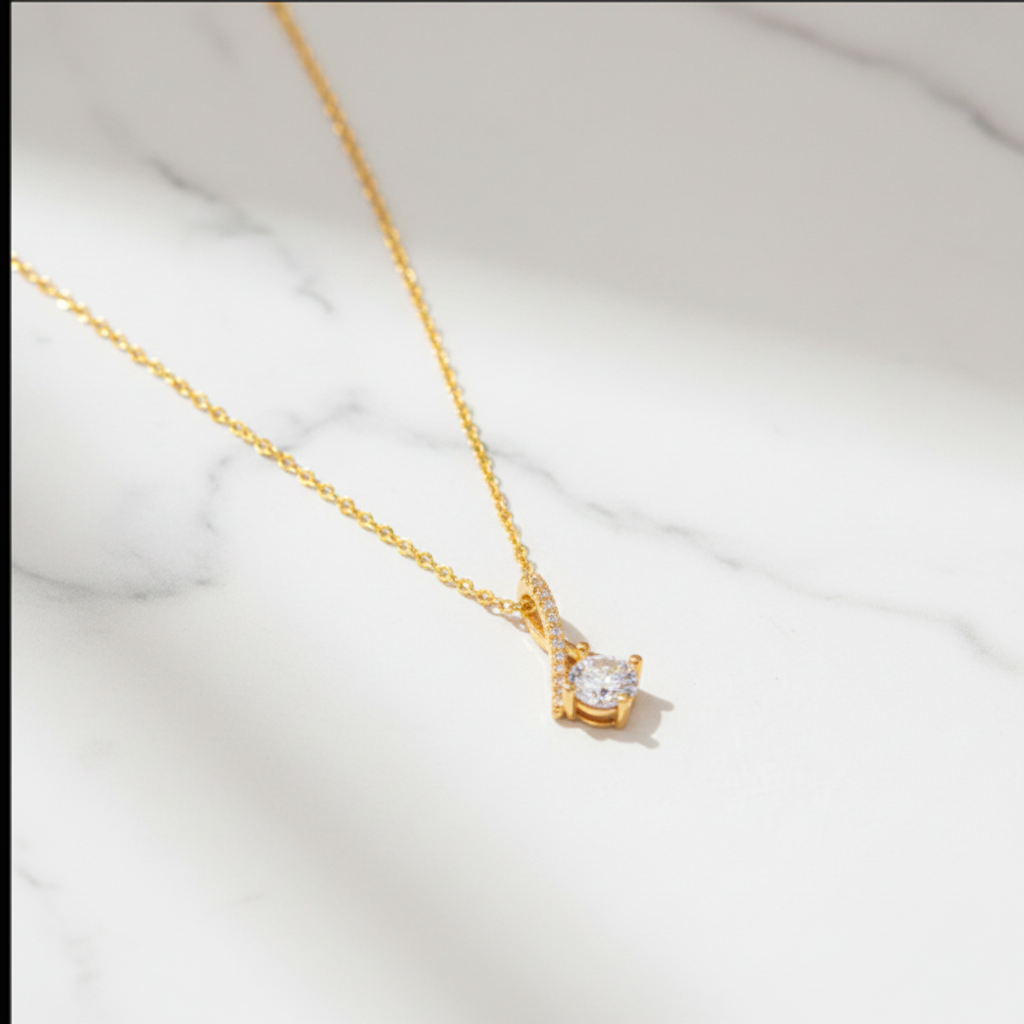 Gold zirconia pendant necklace on white marble