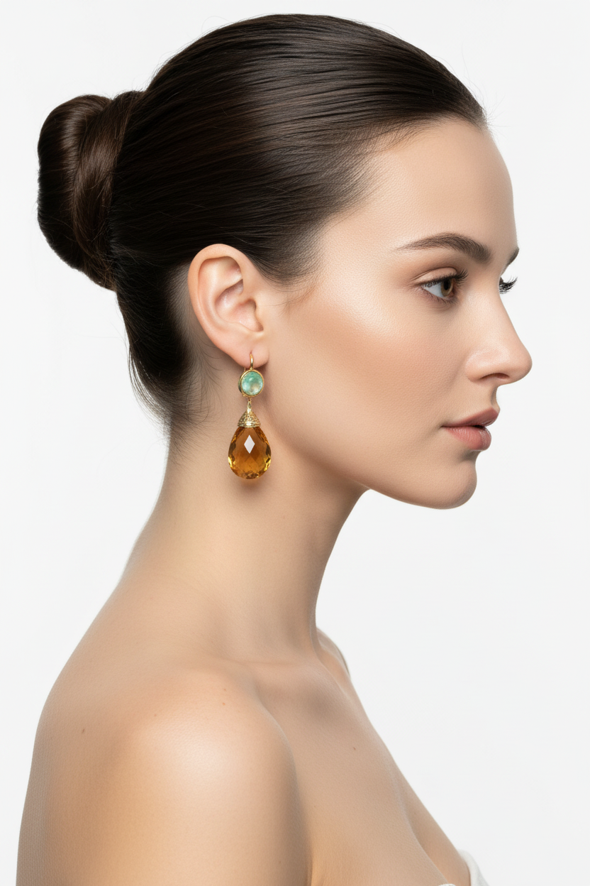 Model in profile with ballerina bun wearing gold waterdrop amber gemstone ear clips, white background