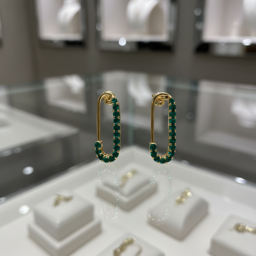 Gold crystal hook earrings on glass counter display