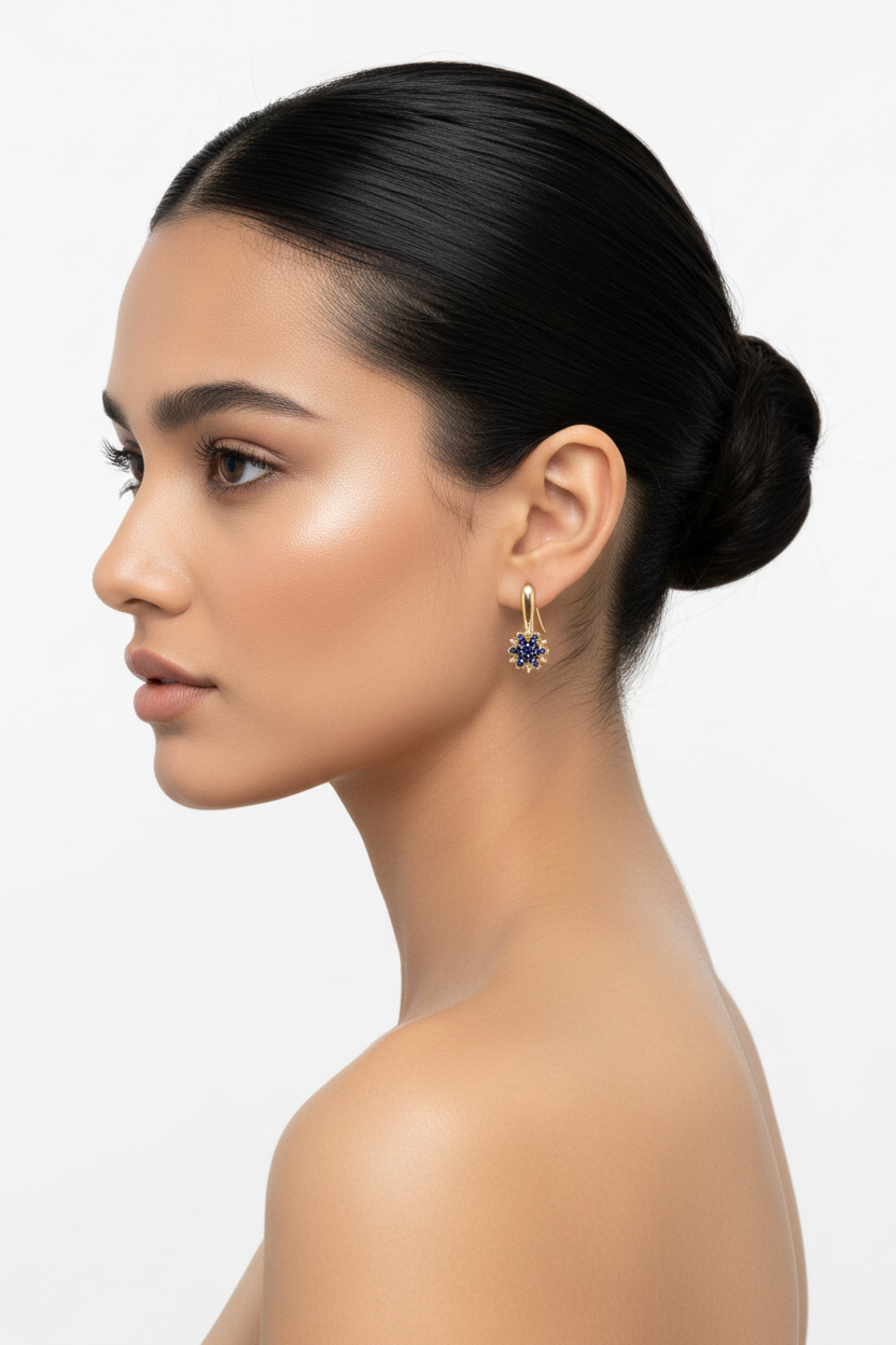 Woman left profile, ballerina bun, gold sapphire sunflower drop earrings