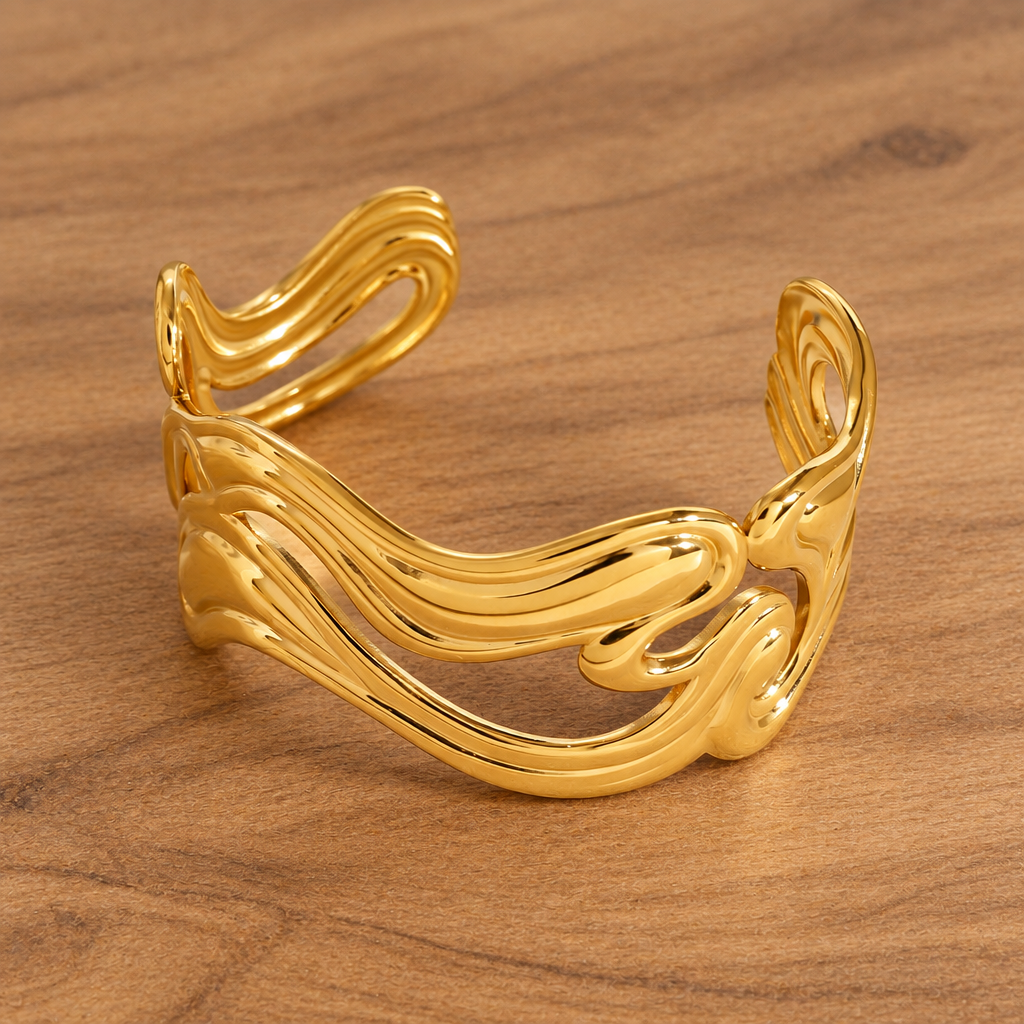 Anissa gold-tone wavy open cuff bracelet on natural wood