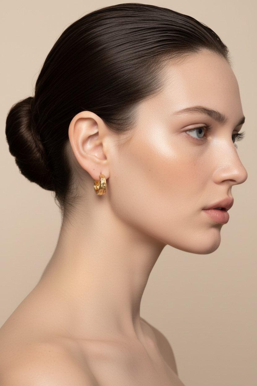 Woman right profile, ballerina bun, gold hoop earrings