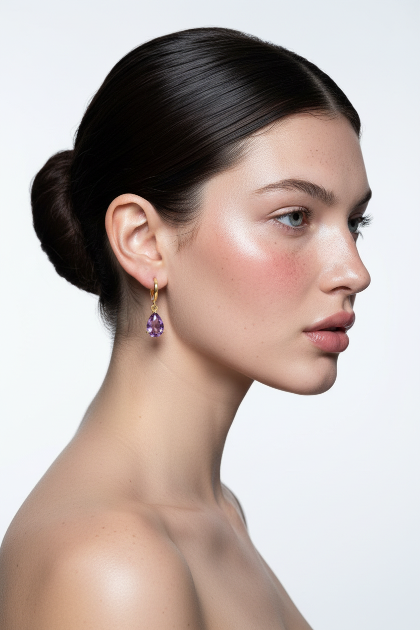 Woman right profile, ballerina bun, gold hoop with purple amethyst teardrop earring