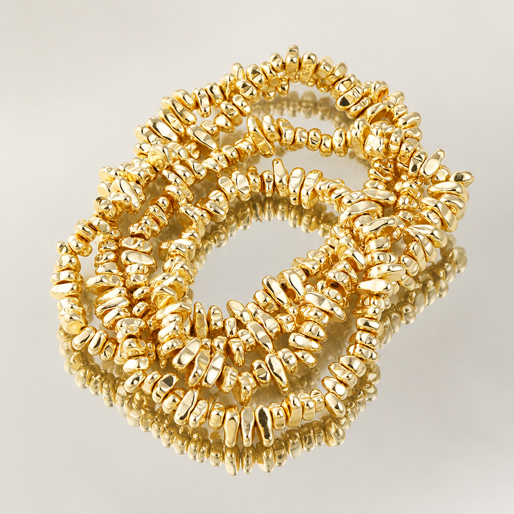 Gold-tone irregular bead bracelet reflected in a mirror