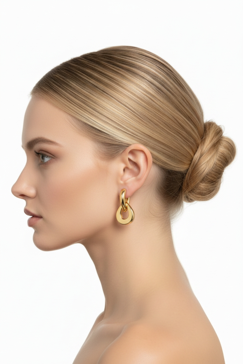 Woman left profile, ballerina bun, chunky gold double-ring interlocked hoop earring